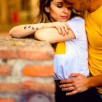 A loving couple in a warm embrace in the streets of Toledo, Spain.
